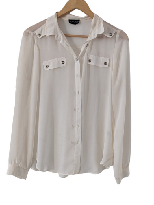 Preloved. Keep cool and stylish in this Topshop cream shirt. Made from lightweight sheer fabric, it is available in size 12 and offers a sharp and elegant look.